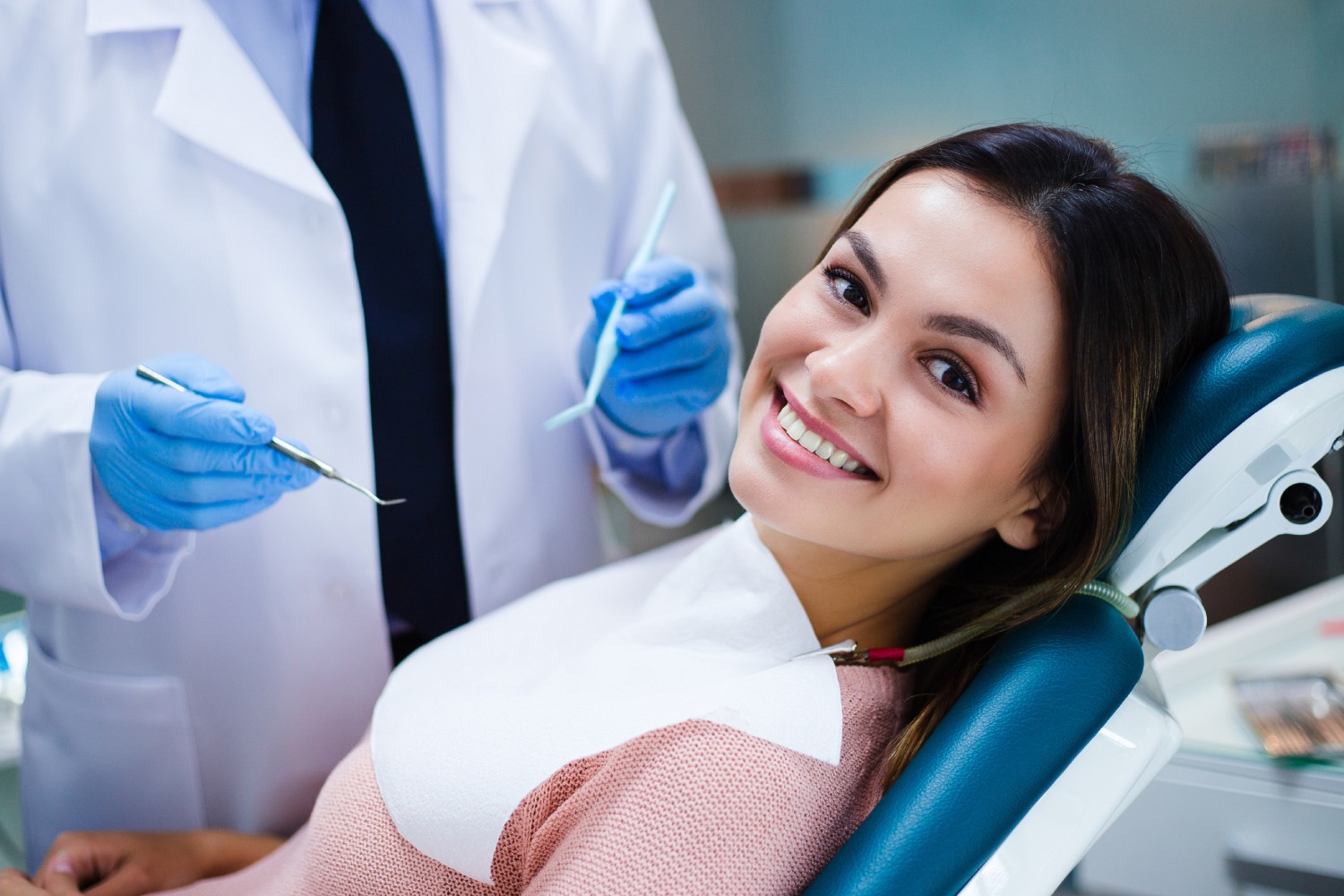 Women With Smiles Sitting In A Dental Office